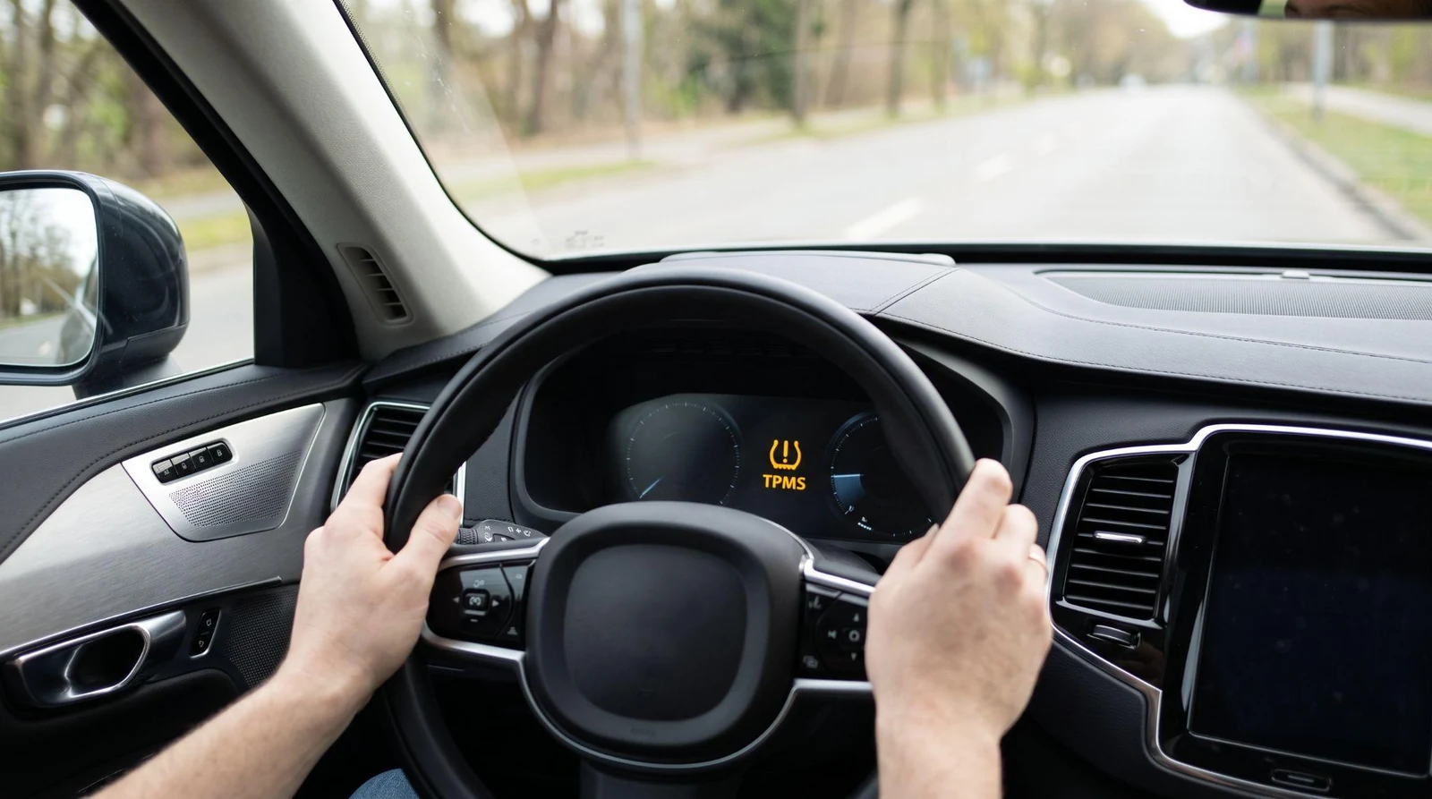 Modern car dashboard with TPMS light.